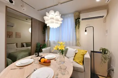 a living room with a dining table and a couch at -Grandir Shibuya- 7-minute walk to Shibuya Station in Tokyo
