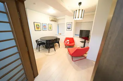 a living room with a dining room table and chairs at Yotsugi House \u56db\u30c4\u6728\u30cf\u30a6\u30b9 in Tokyo