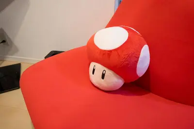 a stuffed animal sitting on top of a red chair at Yotsugi House \u56db\u30c4\u6728\u30cf\u30a6\u30b9 in Tokyo