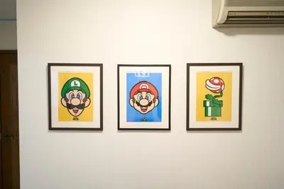 a group of four pictures on a wall at Yotsugi House \u56db\u30c4\u6728\u30cf\u30a6\u30b9 in Tokyo