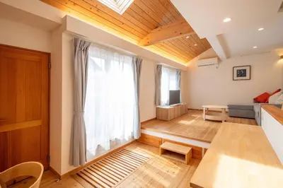 a living room with a large window and a couch at \u3080\u304f\u306e\u5bb6 \u6d66\u5b89 in Tokyo
