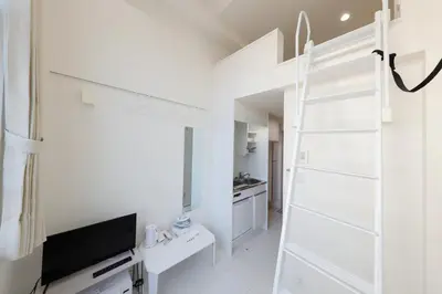 a white room with a ladder and a television at monthly Nano Kamiochiai in Tokyo