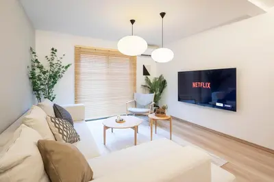 a living room with a white couch and a tv at \u548c\u8239 wafune in Tokyo