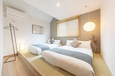 a bedroom with two beds and a window at \u548c\u8239 wafune in Tokyo