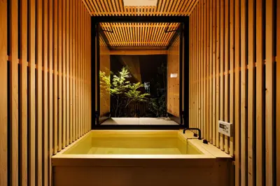 a bath tub in a room with a window at Yohaku Tokyo in Tokyo