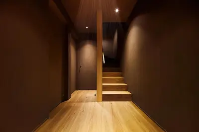 a staircase in a room with wood floors and a pole at Yohaku Tokyo in Tokyo