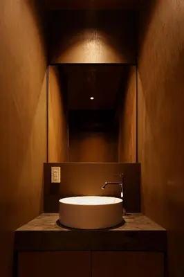 a bathroom sink with a large mirror above it at Yohaku Tokyo in Tokyo
