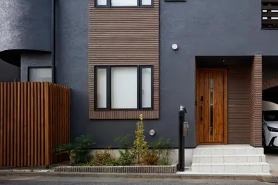 a house with a wooden door and a fence at Yohaku Tokyo in Tokyo