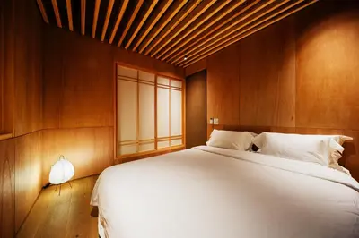 a bedroom with a large white bed and a window at Yohaku Tokyo in Tokyo