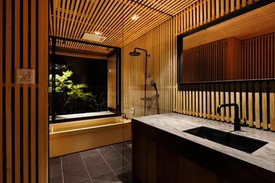 a bathroom with a sink and a window and a tub at Yohaku Tokyo in Tokyo