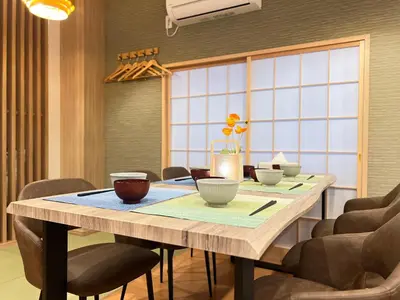 a dining room with a table with bowls on it at nestay suite tokyo skytree in Tokyo