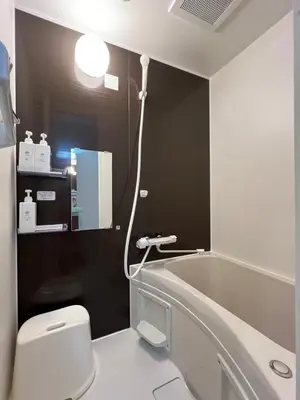 a bathroom with a toilet and a bath tub at nestay suite tokyo skytree in Tokyo