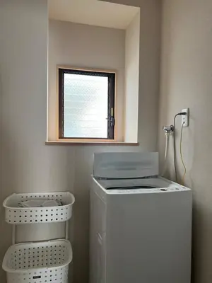 a washing machine in a bathroom with a window at nestay suite tokyo skytree in Tokyo