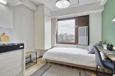 a small bedroom with a bed and a window at CraftFlat Komagome 502, a compact studio at excellent location in Tokyo