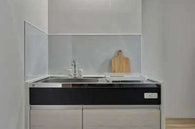 a kitchen with a sink and a counter at CraftFlat Komagome 502, a compact studio at excellent location in Tokyo