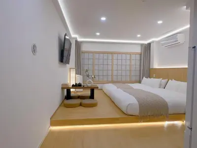 a bedroom with a large bed and a table at star house akihabara ueno tokyo in Tokyo