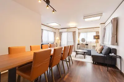 a dining room with a long table and chairs at Casita Dulce in Tokyo