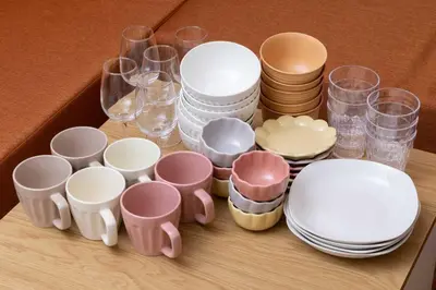 a table with cups and plates and glasses at Casita Dulce in Tokyo