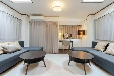 a living room with a blue couch and a table at Casita Dulce in Tokyo