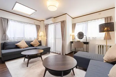 a living room with a couch and a table at Casita Dulce in Tokyo