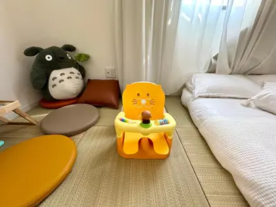 a childs bedroom with a bed and a toy cat on the floor at Motosakura 301, direct access to Narita and Haneda, 2 beds, 5 train lines, elevator, free bicycle rental, luxury double bed in Tokyo