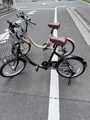two bikes parked on the side of a street at Motosakura 301, direct access to Narita and Haneda, 2 beds, 5 train lines, elevator, free bicycle rental, luxury double bed in Tokyo
