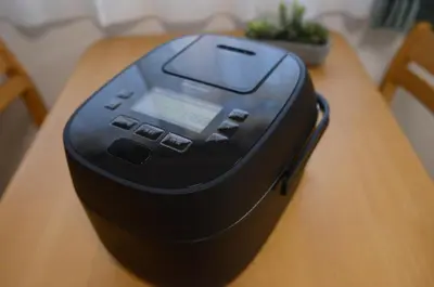 a electronic device sitting on a wooden table at Motosakura 301, direct access to Narita and Haneda, 2 beds, 5 train lines, elevator, free bicycle rental, luxury double bed in Tokyo
