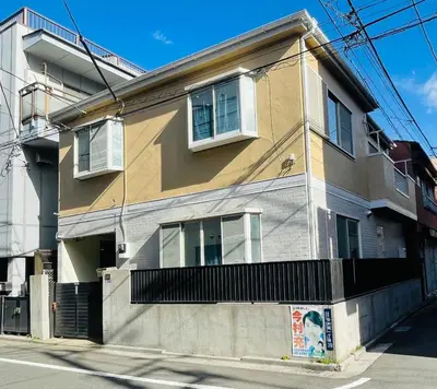 a building on the corner of a street at New Tokyo Asakusa Area Emi House in Tokyo