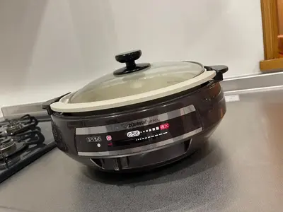 a slow cooker sitting on a stove in a kitchen at New Tokyo Asakusa Area Emi House in Tokyo
