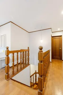 a staircase in a room with white walls and wooden floors at New Tokyo Asakusa Area Emi House in Tokyo