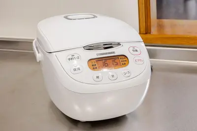 a toaster sitting on the floor with an orange clock at New Tokyo Asakusa Area Emi House in Tokyo
