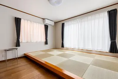 a bedroom with a checkered floor and large windows at New Tokyo Asakusa Area Emi House in Tokyo