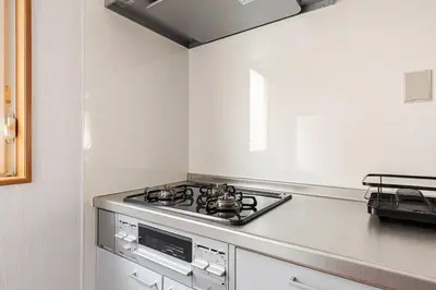 a stove top oven in a white kitchen at New Tokyo Asakusa Area Emi House in Tokyo