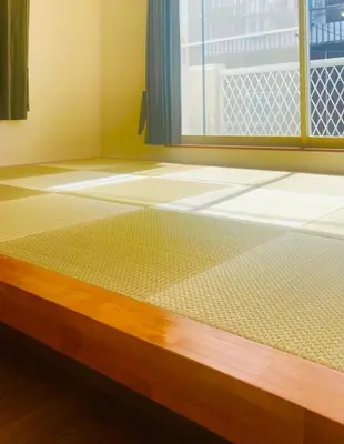 a room with a mattress on a floor with a window at New Tokyo Asakusa Area Emi House in Tokyo