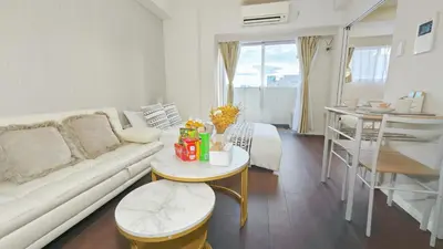 a living room with a white couch and a table at \u9326\u7cf8\u753a-1104 in Tokyo
