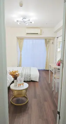 a living room with a bed and a table at \u9326\u7cf8\u753a-1104 in Tokyo
