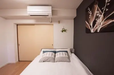 a bedroom with a white bed with two pillows at Ikebukuro\u4e2d\u5ddd405-TS0041 in Tokyo