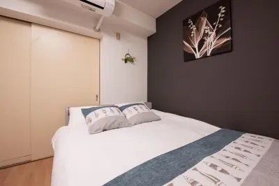 a bedroom with a white bed with two pillows at Ikebukuro\u4e2d\u5ddd405-TS0041 in Tokyo