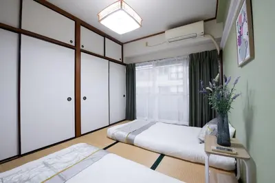 a bedroom with two beds and a window at Ikebukuro\u4e2d\u5ddd405-TS0041 in Tokyo