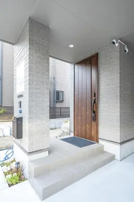 a front door of a house with a wooden door at Skytree House Oshiage New 3-story Villa, 2 Showers, 2 Toilets, 4 Rooms, 3 min walk to Oshiage Station in Tokyo