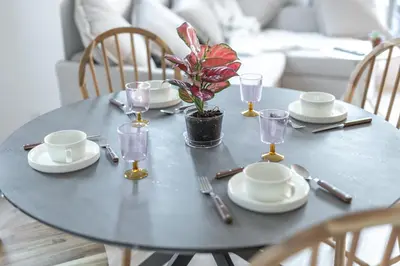 a table with plates and glasses and a plant on it at Skytree House Oshiage New 3-story Villa, 2 Showers, 2 Toilets, 4 Rooms, 3 min walk to Oshiage Station in Tokyo