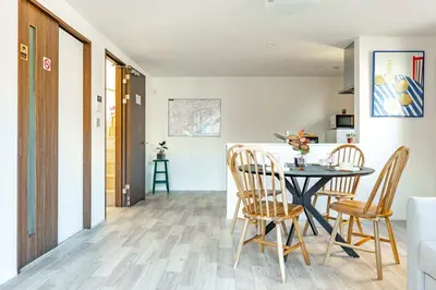 a kitchen and dining room with a table and chairs at Skytree House Oshiage New 3-story Villa, 2 Showers, 2 Toilets, 4 Rooms, 3 min walk to Oshiage Station in Tokyo