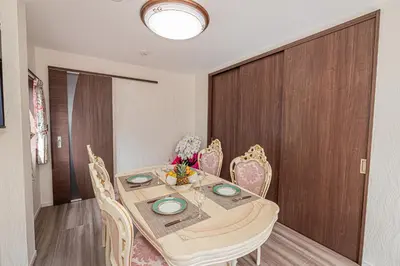 a dining room with a wooden table and chairs at KTV Party House 3min to Itabashi Station Traditional Street Stay in Tokyo