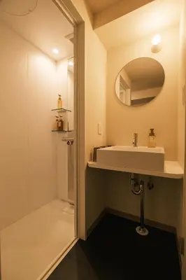 a bathroom with a sink and a mirror at IKISUMI HOTEL in Otsuka in Tokyo