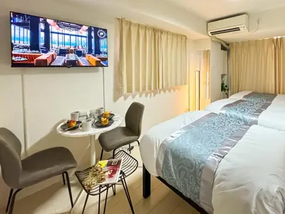 a hotel room with a bed and a tv at Tower View Stay Kinchicho in Tokyo