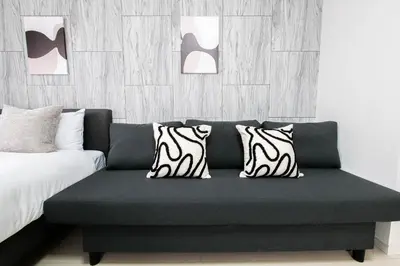 a couch with zebra pillows in a bedroom at Tower View Stay Kinchicho in Tokyo