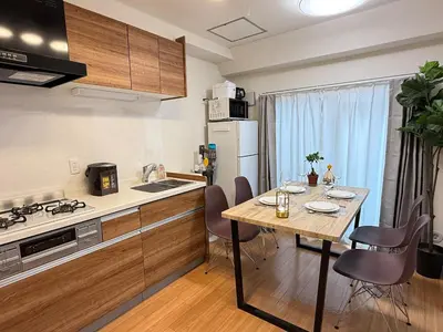 a kitchen with a wooden table and a kitchen with a dining room at Moto Sakura 502,Asakusa Ueno Great location 2 bedrooms,3 beds,6 Direct access to Narita and Haneda Airports,5 train lines available in Tokyo