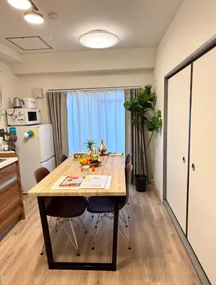 a kitchen with a dining room table with chairs at Moto Sakura 502,Asakusa Ueno Great location 2 bedrooms,3 beds,6 Direct access to Narita and Haneda Airports,5 train lines available in Tokyo