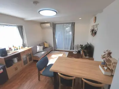 a living room with a table and a couch at LY-shinjuku-house SJ0432 in Tokyo