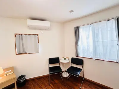 a room with a table and two chairs and a window at LY-shinjuku-house SJ0432 in Tokyo